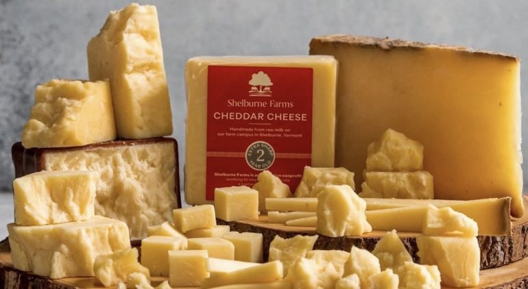 cheddar cheese on a wooden board